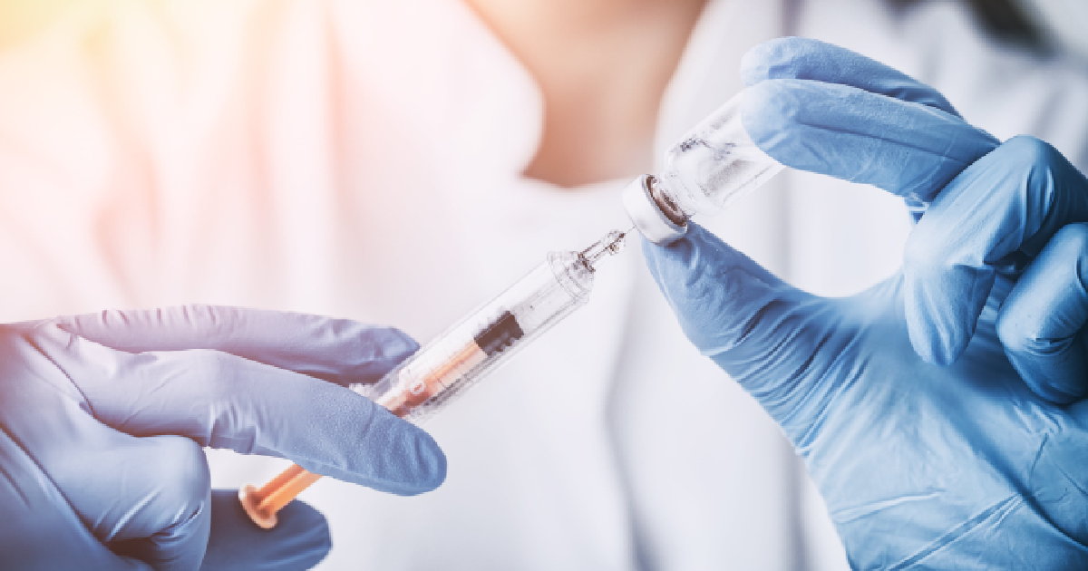 Close-up of a healthcare professional drawing medication into a syringe, illustrating preparation techniques during Injection Training in Houston, TX.
