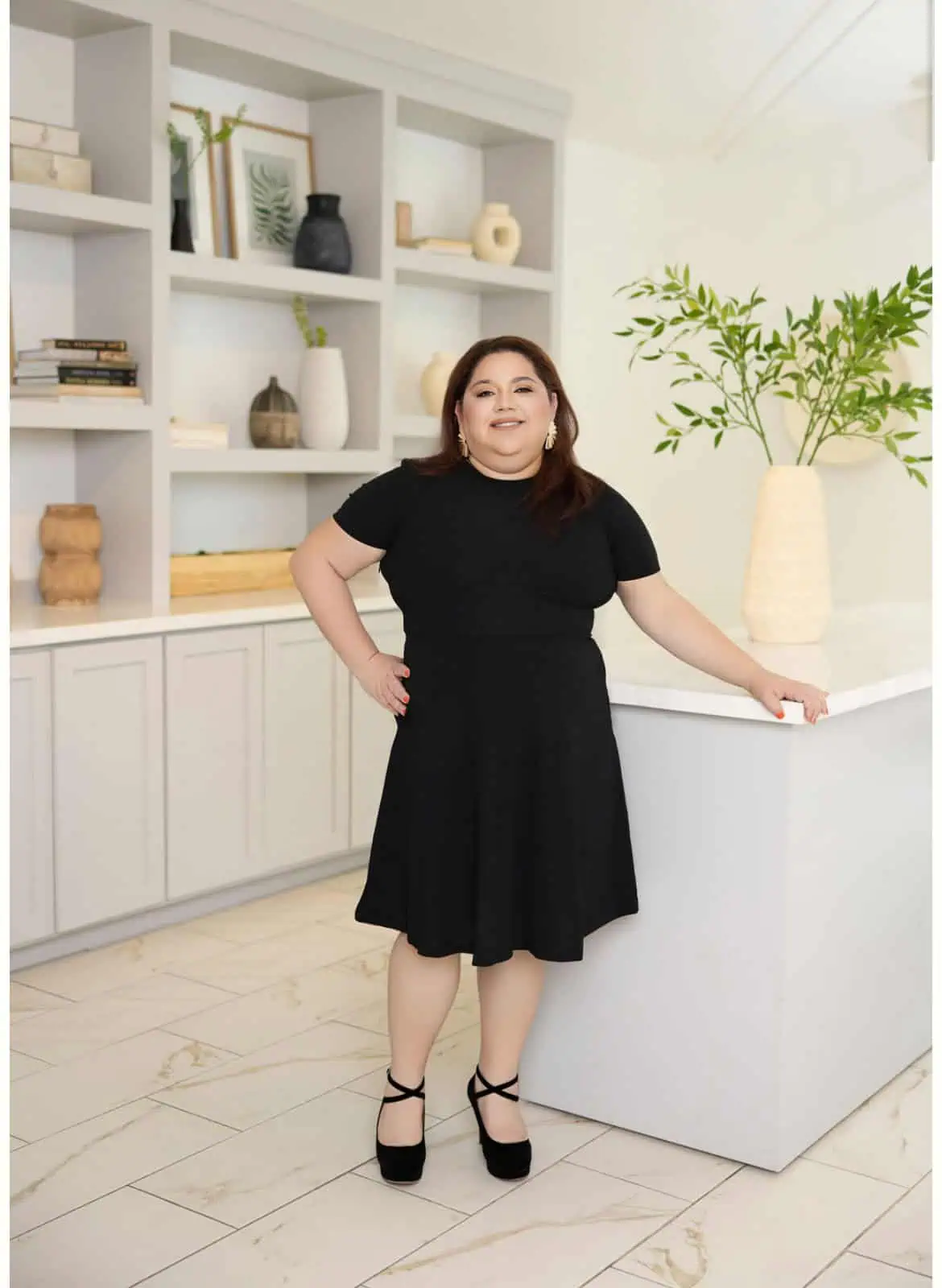 Yuleidis Dominguez, Office Manager, smiling while standing inside The Better Body Shop Medspa, Houston, TX.